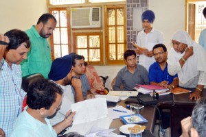 Deputy Commissioner Jammu Simrandeep Singh listening grievances of people at R S Pura SDM office.
