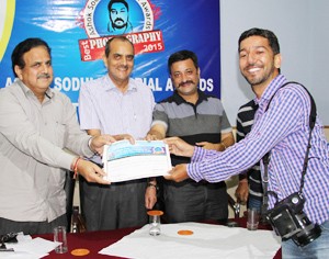 Excelsior Lensman Rakesh Bakshi receiving Ashok Sodhi Memorial Photography Award of PCJ at Jammu on Monday.