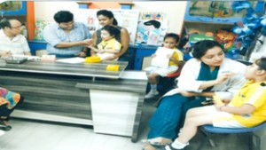 Children being examined during free dental check-up camp.
