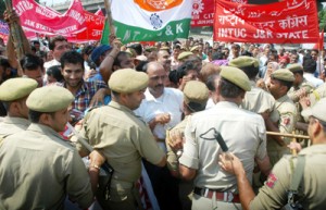 Protesting CITU workers being stopped by police near Dogra Chowk in Jammu on Wednesday.                   -Excelsior/ Rakesh