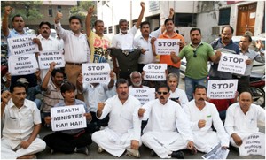NPP leaders and workers protesting outside Directorate of Health in Jammu on Monday.