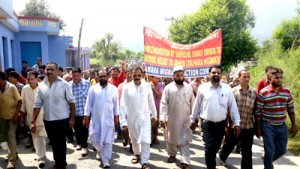 Talwara migrants, led by Balwant Singh Mankotia, taking out a protest march on Wednesday.