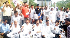 JKNPP activists holding demonstration outside Raj Bhawan at Jammu on Saturday. 