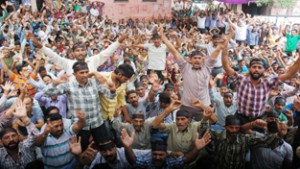 PHE workers staging protest demonstration outside Chief Engineer’s office on BC Road in Jammu on Monday. -Excelsior/ Rakesh
