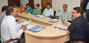 Minister for PWD Syed Mohamaad Altaf Bukhari chairing a meeting at New Delhi on Thursday.