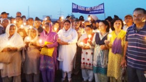 Family members of ex-servicemen taking out candle light march for OROP on Friday.