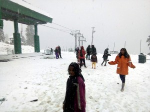 Tourists enjoying season's first snowfall in Gulmarg on Saturday.-Excelsior/Aabid Nabi