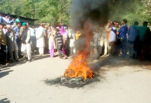 Villagers protesting against police on road at Potha in Surankote on Thursday.