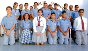 Selected swimmers of KC Public School posing alongwith School Principal A K Mishra on Monday.