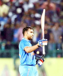 Rohit Sharma celebrates after completing his century during their first Twenty-20 cricket match against South Africa at Dharamsala on Friday. (UNI)