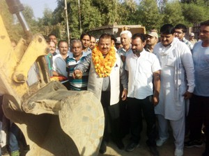 Minister for Industries, Chander Prakash Ganga kick starting up-gradation of Purmandal road on Friday.      -Excelsior/Gautam