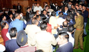 National Conference and Congress members providing cover to Independent MLA Engineer Abdul Rashid, as BJP members assaulted him on the issue of a ‘Beef party’ at MLA Hostel in Srinagar on Thursday. (UNI)
