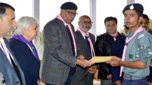 Governor N N Vohra presenting Rajya Puraskar to a Scount in Srinagar on Monday.