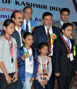 Minister for R&B, Altaf Bukhari posing alongwith medal winners of Yoga Championship in Srinagar. 