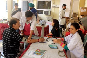 Doctors examining people during free medical camp at Panchbakhtar temple on Saturday.