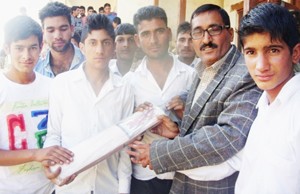 Students showing cricket bat received from RR Battalion.