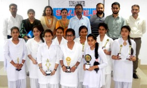 Winners of symposium posing alongwith dignitaries at Udhampur on Thursday. 