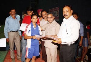 Chief guest felicitating a player during Kabaddi Tournament in Jammu.