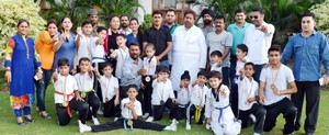 Winners of medals in Kick Boxing Championship posing for a group photograph alongwith former Minister, Raman Bhalla in Jammu on Thursday. 