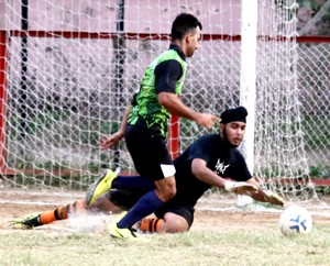 Goalkeeper depending a goal during a match at GGM Science College ground on Monday.