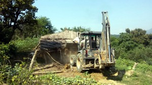 A JCB demolishing structure raised on forest land in Basohli  on Saturday.