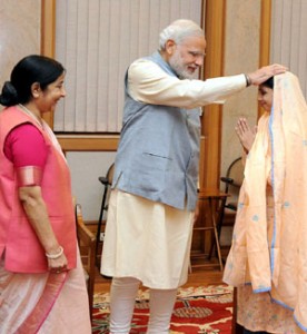 Geeta, a deaf-mute Indian girl who accidentally crossed over to Pakistan, a decade ago, meeting the Prime Minister, Narendra Modi after her return to India, in New Delhi on Monday. External Affairs and Overseas Indian Affairs Minister, Sushma Swaraj is also seen in the picture.(UNI)