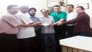 JKOPA members handing over cash assistance to a needy employee of Printing Industry at Jammu.