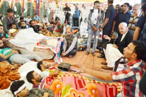 National Conference Party President Dr Farooq Abdullah interacting with members of All J&K National Youth Corps (NYC) at Pratap Park, Srinagar on Tuesday. —Excelsior/Amir War