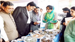 Minister of State for PHE, Abdul Majeed Padder having a look at food products after inaugurating Forest Food Festival at Srinagar.