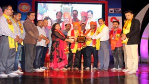 Guests honouring winner of Devotional Song Competition on 6th day of Navratra Festival.