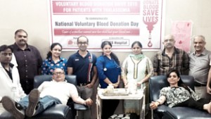 Volunteers donating blood during camp at Jammu on Sunday.
