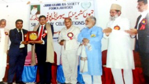 Principal District and Sessions Judge Poonch Tahir Khurshid Raina being presented award on Monday.