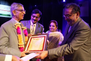 Minister of Finance, Dr Haseeb A Drabu flanked by MoS Education, Priya Sethi presenting award during a ceremony at Srinagar on Wednesday.