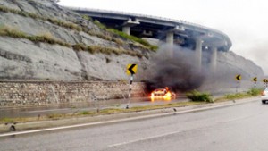 A car in flames near Bantalab Toll Plaza on Jammu-Srinagar National Highway.
