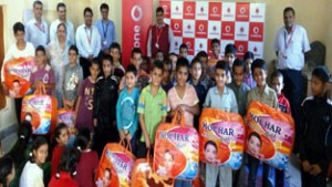 Beneficiaries posing for photograph during woollen donation camp organised by Vodafone at Balgram.