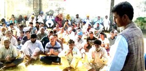 Congress leader Arun Sharma addressing public meeting at village Rara in Vijaypur on Sunday.