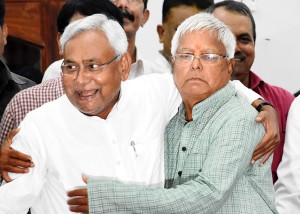 Bihar Chief Minister Nitish Kumar and RJD chief Lalu Prasad greeting each other at a press conference after the victory of Grand Alliance in Bihar Assembly elections in Patna on Sunday. (UNI)