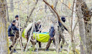 Troops shifting bodies of militants killed at Ashmuqam in Anantnag on Monday.— Excelsior/Sajad Dar
