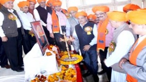 Speaker Kavinder Gupta lighting ceremonial lamp during birth anniversary function of Lala Hans Raj Mahajan on Sunday. -Excelsior/Rakesh