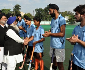 Chief guest and other dignitaries interacting with the players during the inaugural ceremony of the Hockey Tournament at KK Hakhu Astroturf Stadium in Jammu.