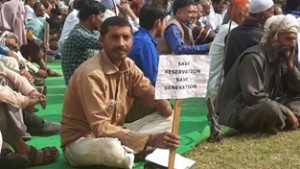 Supporters of Reservation in Promotion holding placards during rally at Reasi on Sunday.
