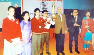 Winners lifting trophy while posing for a group photograph alongwith dignitaries at KC Public School in Jammu.