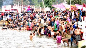 Devotees taking a dip in holy water during Jhiri Mela at Jhiri Kalyanpur on Wednesday. -Excelsior/ Rakesh