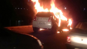 A car which caught fire at Balol bridge near Bari Brahmana on Monday.