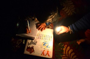 A student studies under the light of candle in Baramulla district.-Excelsior/ Aabid Nabi