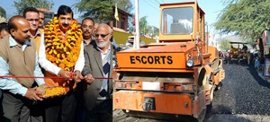 MoS for Finance, Pawan Kumar Gupta kick starting black topping works at Udhampur on Friday.