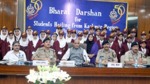 Union Home Minister Rajnath Singh in a group photograph with the school children from J&K who are on a Bharat Darshan tour being conducted by the Border Security Force, in New Delhi on Friday.(UNI)