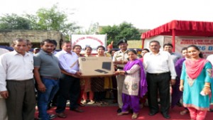 BSF Commandant Hari Lal presenting computer items to school students on Monday.