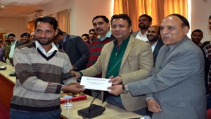 Minister for CAPD, Ch Zulfkar Ali giving away appointment letter to a beneficiary at Rajouri.