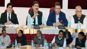 Member Parliament, Jugal Kishore Sharma flanked by Ministers Ch Zulfkar and Abdul Ghani Kohli reviewing the progress of implementation of DDUGJY in a meeting on Saturday.